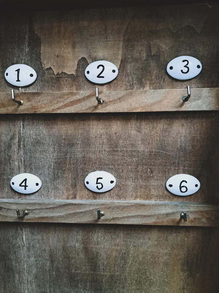 Numbers over Hooks on Wooden Wall
